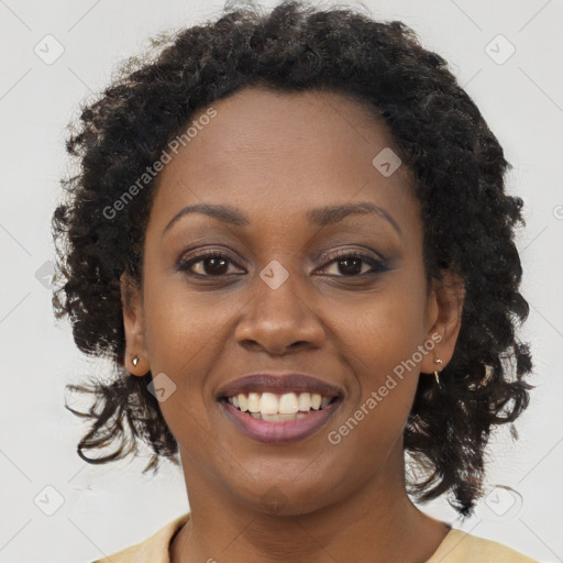 Joyful black young-adult female with long  brown hair and brown eyes