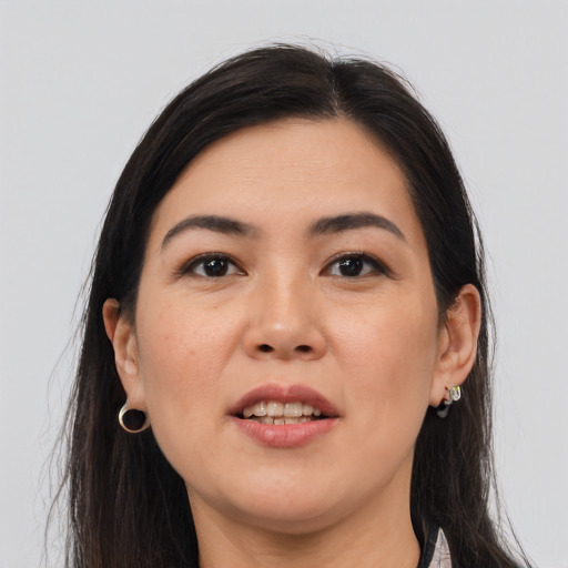 Joyful asian young-adult female with long  brown hair and brown eyes