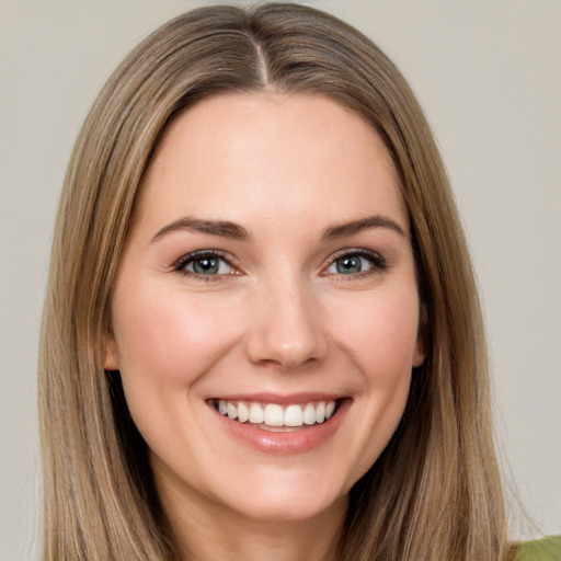 Joyful white young-adult female with long  brown hair and brown eyes