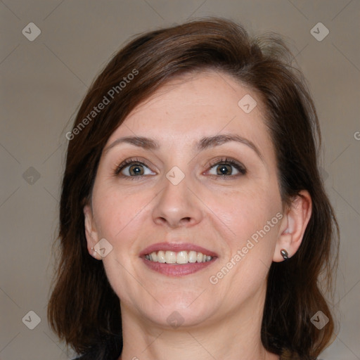 Joyful white adult female with medium  brown hair and grey eyes