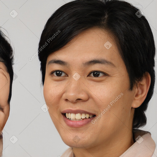 Joyful asian young-adult female with medium  brown hair and brown eyes