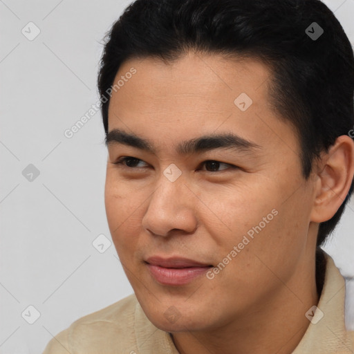 Joyful asian young-adult male with short  black hair and brown eyes