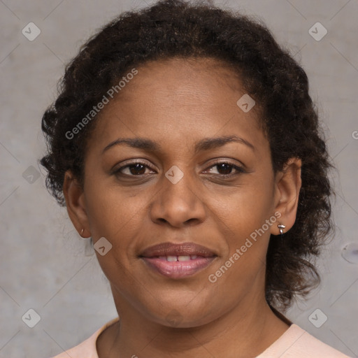 Joyful black adult female with medium  brown hair and brown eyes