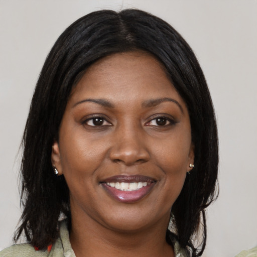 Joyful black young-adult female with medium  black hair and brown eyes