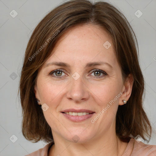 Joyful white adult female with medium  brown hair and grey eyes