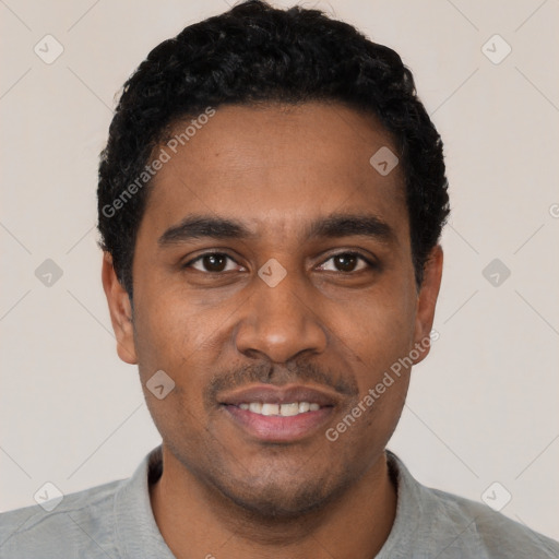 Joyful black young-adult male with short  black hair and brown eyes