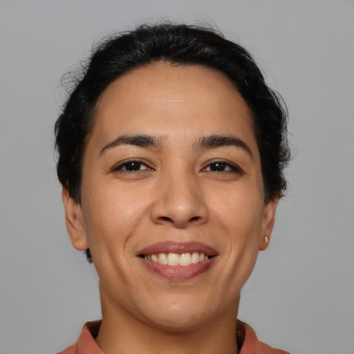 Joyful latino young-adult female with short  brown hair and brown eyes