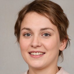 Joyful white young-adult female with medium  brown hair and blue eyes