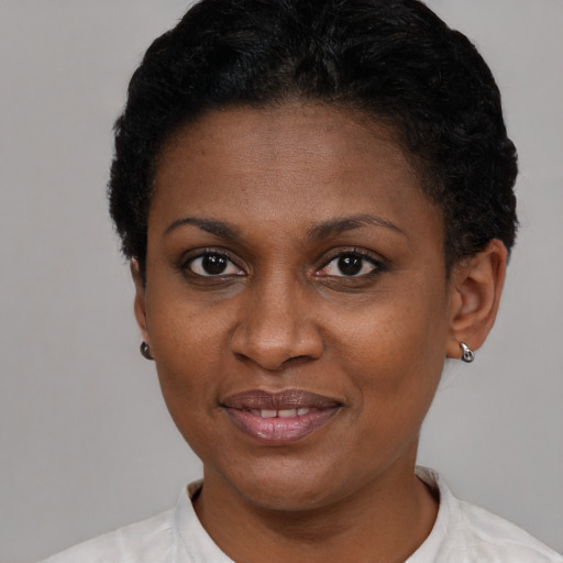 Joyful black adult female with short  brown hair and brown eyes