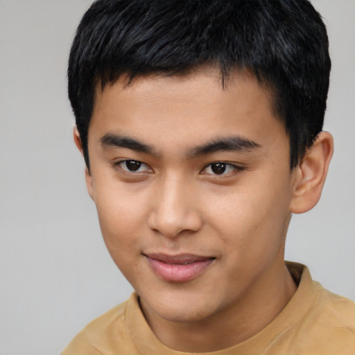 Joyful asian young-adult male with short  black hair and brown eyes