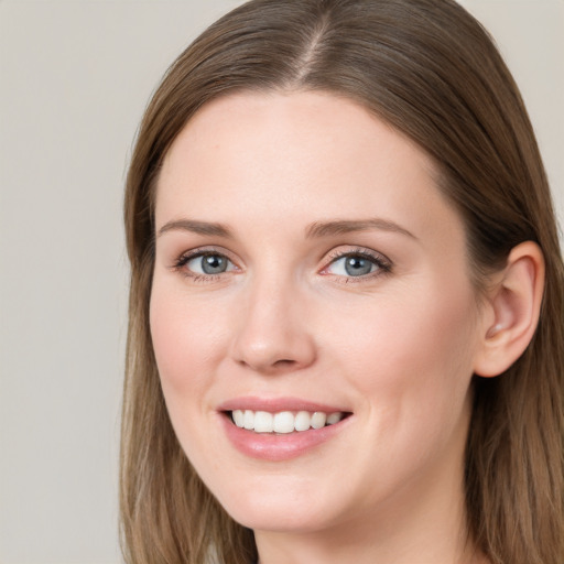 Joyful white young-adult female with long  brown hair and blue eyes