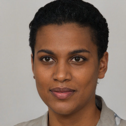 Joyful black young-adult female with short  black hair and brown eyes