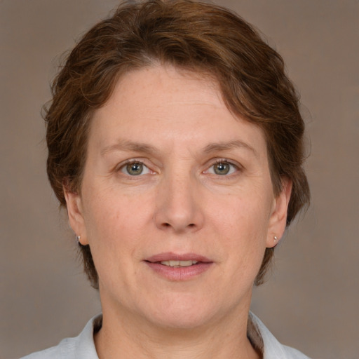 Joyful white adult female with medium  brown hair and grey eyes