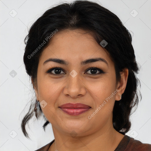 Joyful latino adult female with medium  brown hair and brown eyes