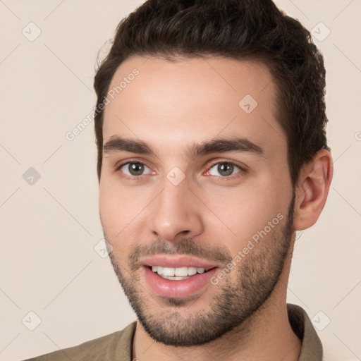 Joyful white young-adult male with short  brown hair and brown eyes