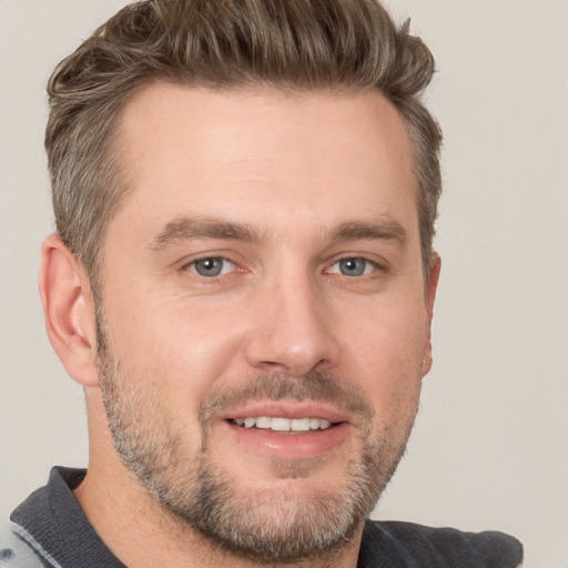 Joyful white adult male with short  brown hair and brown eyes