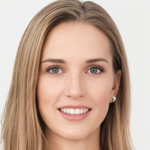 Joyful white young-adult female with long  brown hair and green eyes