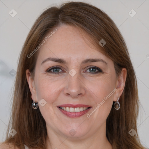 Joyful white adult female with long  brown hair and grey eyes