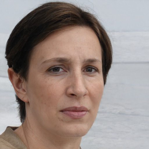 Joyful white adult female with short  brown hair and grey eyes