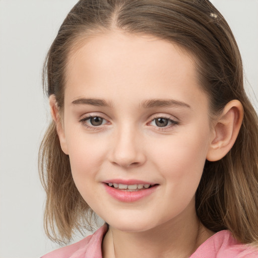 Joyful white child female with medium  brown hair and grey eyes