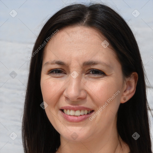 Joyful white adult female with long  brown hair and brown eyes