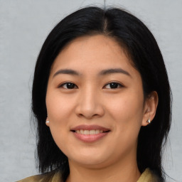 Joyful asian young-adult female with medium  black hair and brown eyes