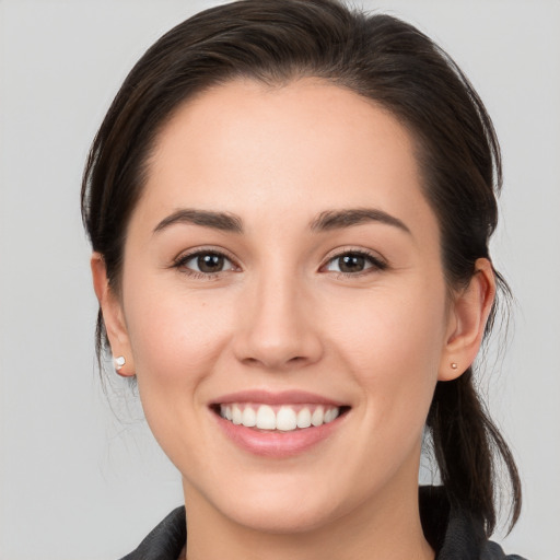 Joyful white young-adult female with medium  brown hair and brown eyes