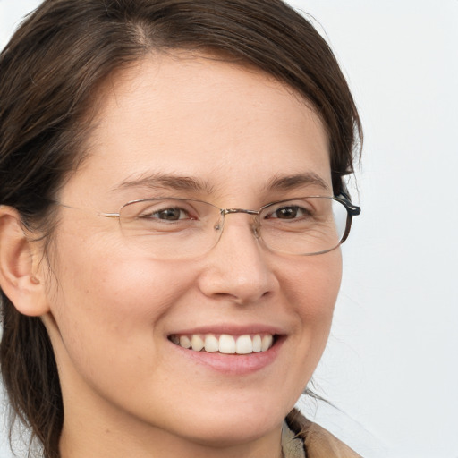 Joyful white adult female with long  brown hair and brown eyes