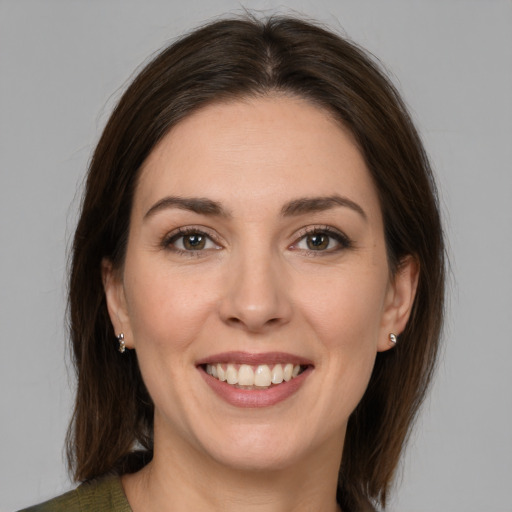 Joyful white young-adult female with medium  brown hair and brown eyes