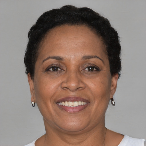 Joyful black adult female with short  brown hair and brown eyes