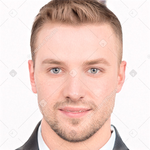 Joyful white young-adult male with short  brown hair and grey eyes