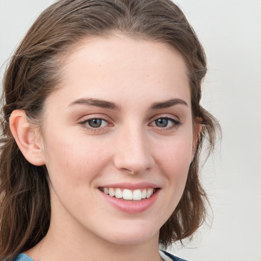 Joyful white young-adult female with medium  brown hair and blue eyes