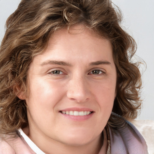 Joyful white young-adult female with medium  brown hair and blue eyes