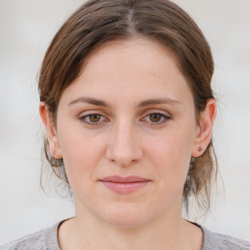 Joyful white young-adult female with medium  brown hair and blue eyes