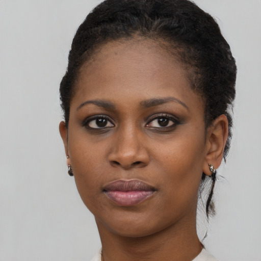 Joyful black young-adult female with short  black hair and brown eyes