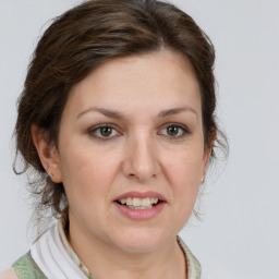 Joyful white young-adult female with medium  brown hair and grey eyes