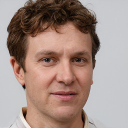 Joyful white adult male with short  brown hair and grey eyes