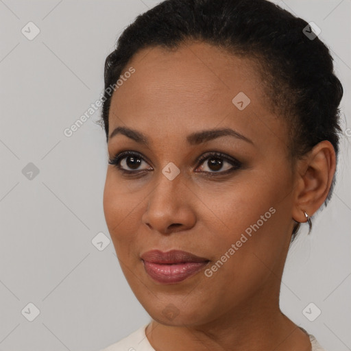 Joyful black young-adult female with short  brown hair and brown eyes