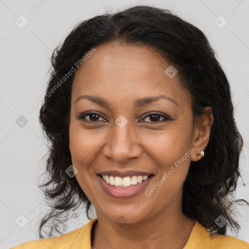 Joyful black adult female with medium  brown hair and brown eyes