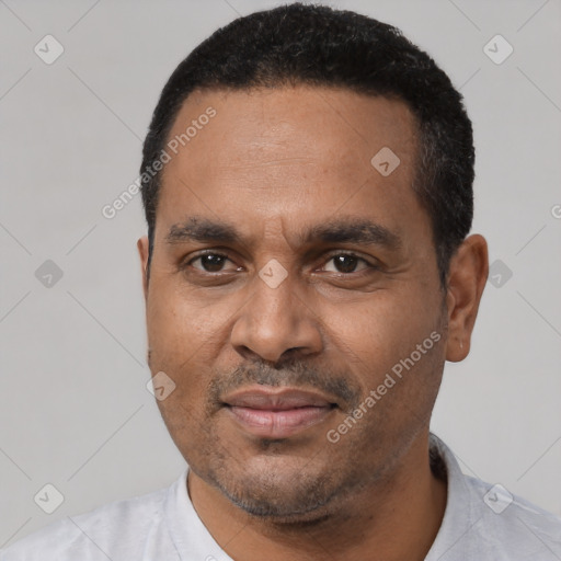 Joyful latino adult male with short  black hair and brown eyes