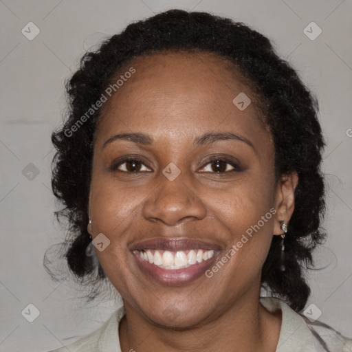 Joyful black adult female with medium  brown hair and brown eyes