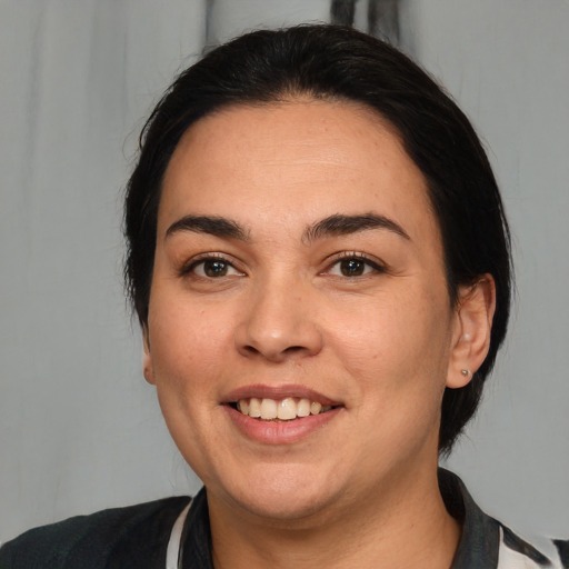 Joyful white young-adult female with medium  black hair and brown eyes