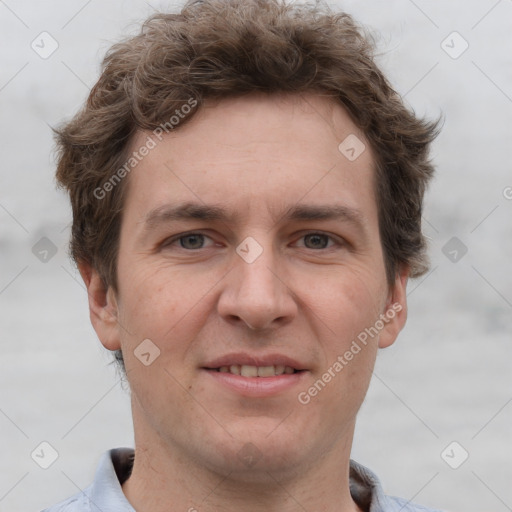 Joyful white adult male with short  brown hair and grey eyes