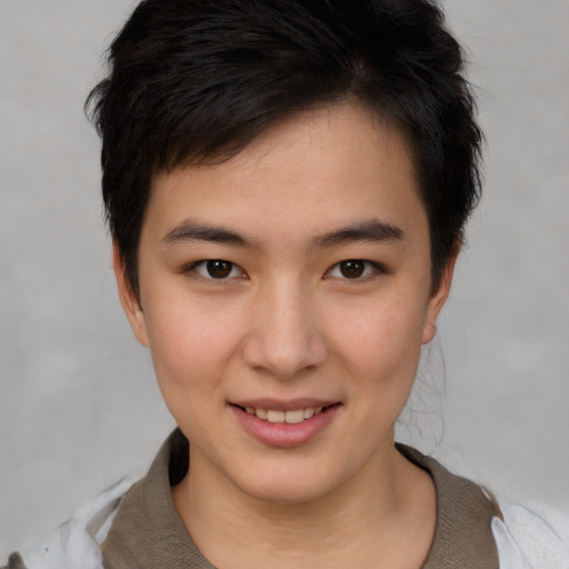 Joyful asian young-adult female with short  brown hair and brown eyes