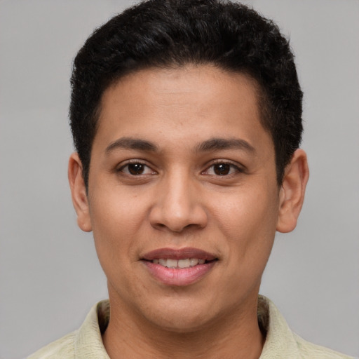 Joyful latino young-adult male with short  brown hair and brown eyes