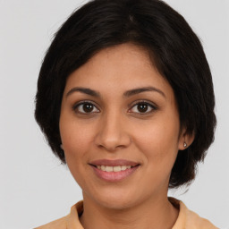 Joyful white young-adult female with medium  brown hair and brown eyes