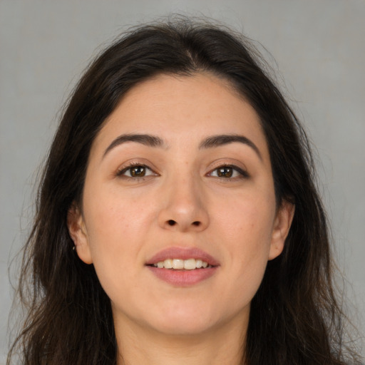 Joyful asian young-adult female with long  brown hair and brown eyes