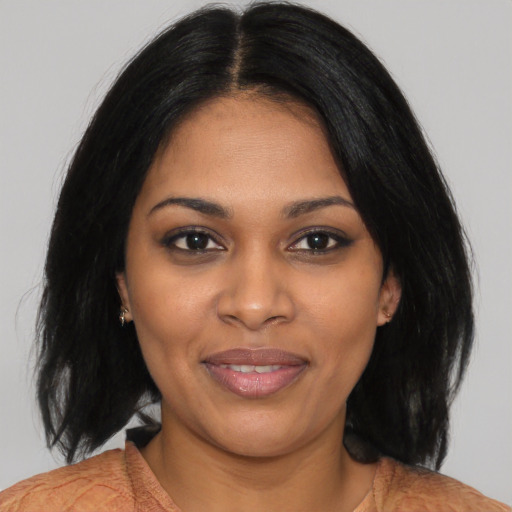 Joyful black young-adult female with medium  black hair and brown eyes