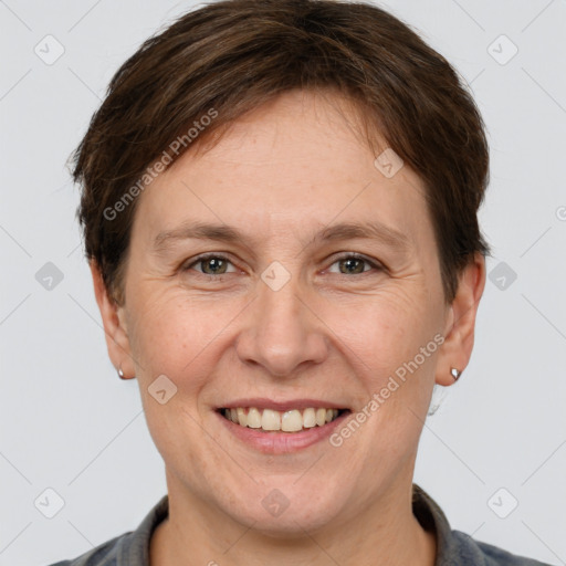 Joyful white adult female with short  brown hair and grey eyes