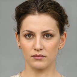 Neutral white young-adult female with medium  brown hair and grey eyes